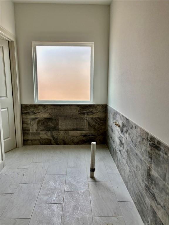 841 Bellagiola Ave, Tontitown, AR 72762 - bathroom featuring a wainscoted wall and tile walls