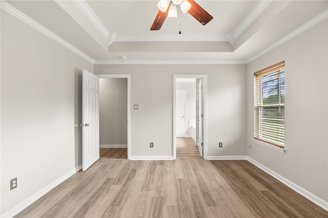 8001 Mars Hill Rd, Ar, AR 72011 - unfurnished bedroom featuring light wood-style flooring, a tray ceiling, crown molding, baseboards, and ceiling fan