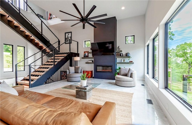 675 N Cliffside Dr, Fayetteville, AR 72701 - living area featuring stairs, plenty of natural light, a fireplace, a high ceiling, and recessed lighting