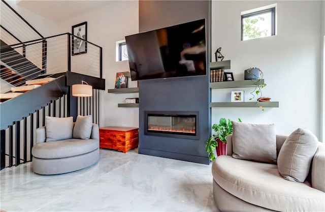 675 N Cliffside Dr, Fayetteville, AR 72701 - living room with marble tiled flooring, a glass covered fireplace, and plenty of natural light
