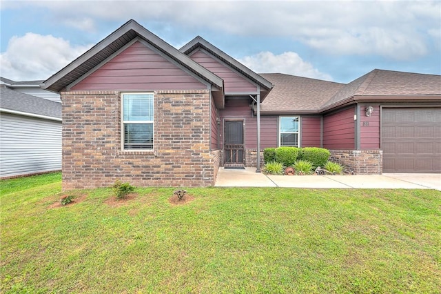 811 SW Pure Globe St, Bentonville, AR 72712 - view of front of home featuring an attached garage, brick siding, a front lawn, and driveway