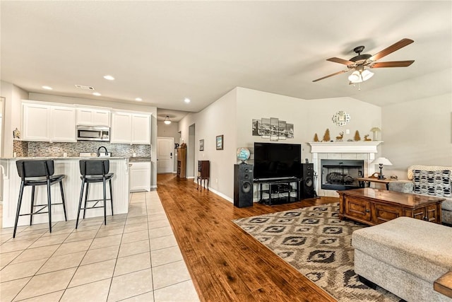 811 SW Pure Globe St, Bentonville, AR 72712 - living room with a ceiling fan, a fireplace, recessed lighting, and light wood-type flooring