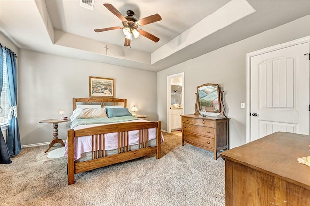 811 SW Pure Globe St, Bentonville, AR 72712 - bedroom featuring a tray ceiling, light carpet, baseboards, a ceiling fan, and connected bathroom