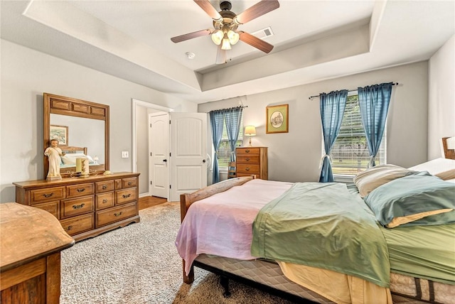 811 SW Pure Globe St, Bentonville, AR 72712 - bedroom featuring a raised ceiling, multiple windows, and a ceiling fan
