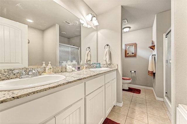 811 SW Pure Globe St, Bentonville, AR 72712 - full bath with toilet, double vanity, a stall shower, tile patterned flooring, and baseboards