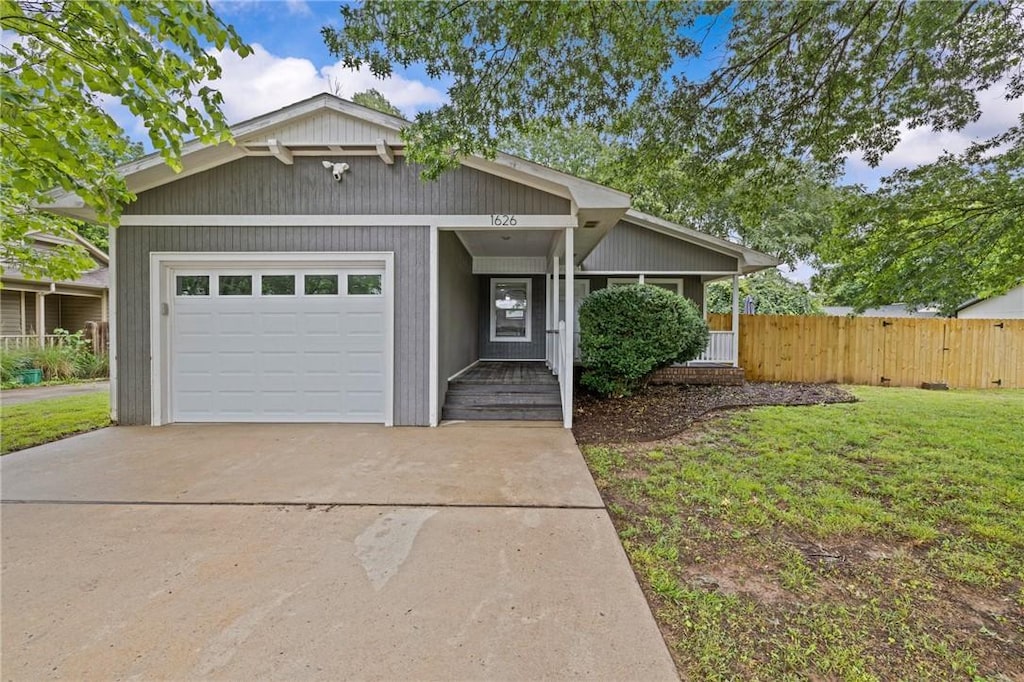 1626 N Salem Rd, Fayetteville, AR 72704 - mid-century modern home with driveway and an attached garage