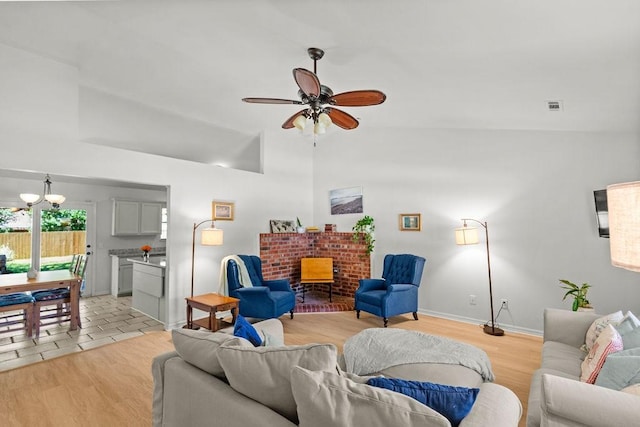 1110 Meadowlark Ln, Siloam Springs, AR 72761 - living room with a chandelier, ceiling fan, light wood finished floors, baseboards, and lofted ceiling