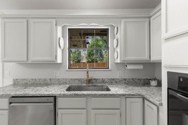1110 Meadowlark Ln, Siloam Springs, AR 72761 - kitchen with stainless steel dishwasher, oven, a sink, and white cabinets