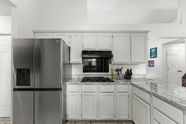 1110 Meadowlark Ln, Siloam Springs, AR 72761 - kitchen featuring stainless steel fridge with ice dispenser, under cabinet range hood, gas stovetop, light stone counters, and a peninsula
