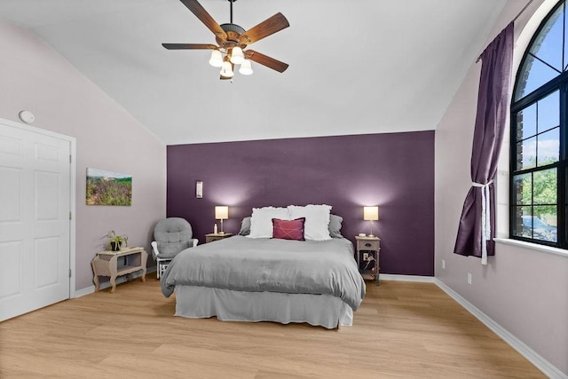 1110 Meadowlark Ln, Siloam Springs, AR 72761 - bedroom with vaulted ceiling, an accent wall, wood finished floors, baseboards, and ceiling fan