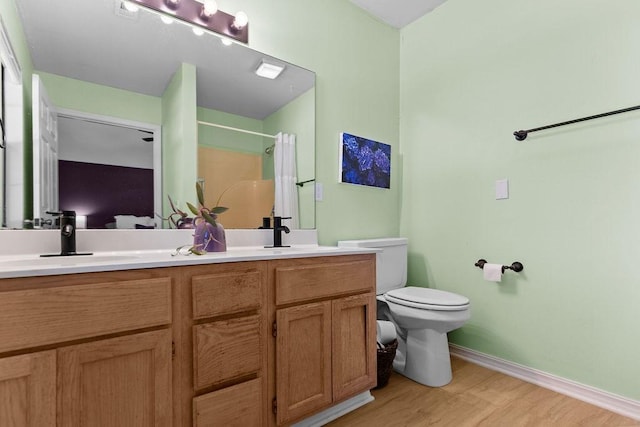1110 Meadowlark Ln, Siloam Springs, AR 72761 - full bathroom featuring double vanity, wood finished floors, toilet, baseboards, and curtained shower