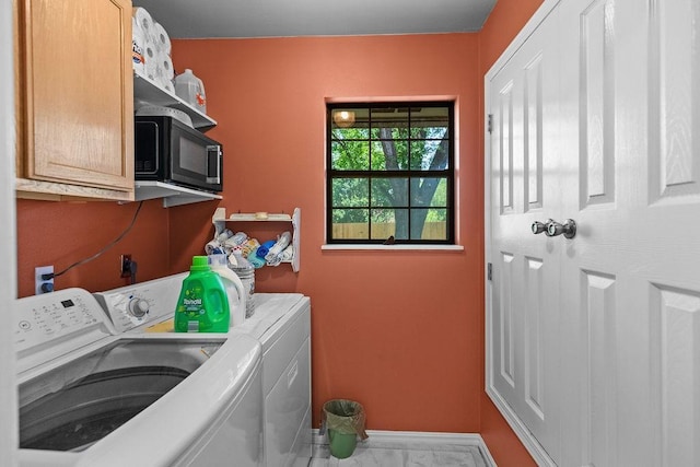 1110 Meadowlark Ln, Siloam Springs, AR 72761 - washroom featuring separate washer and dryer, cabinet space, baseboards, and marble look tile flooring