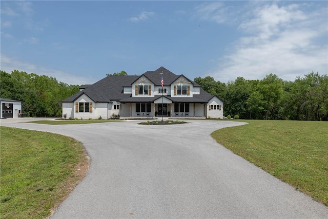 2762 Wilson Ln, Fayetteville, AR 72703 - modern farmhouse with covered porch, a front lawn, and curved driveway