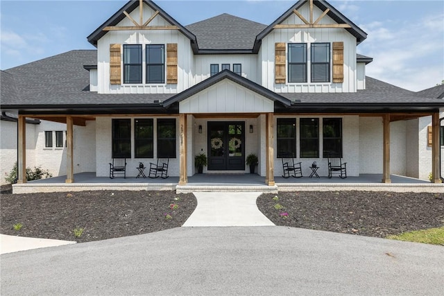 2762 Wilson Ln, Fayetteville, AR 72703 - modern farmhouse style home featuring a porch, brick siding, and a shingled roof