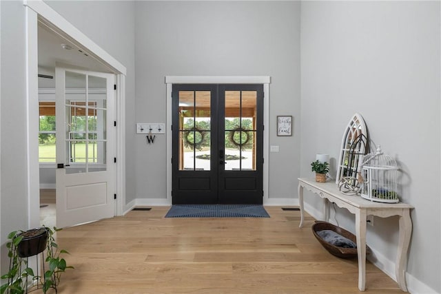 2762 Wilson Ln, Fayetteville, AR 72703 - foyer entrance with french doors, light wood finished floors, a high ceiling, and baseboards