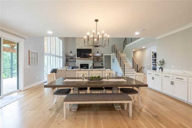 2762 Wilson Ln, Fayetteville, AR 72703 - dining room featuring a fireplace, light wood finished floors, a chandelier, baseboards, and recessed lighting