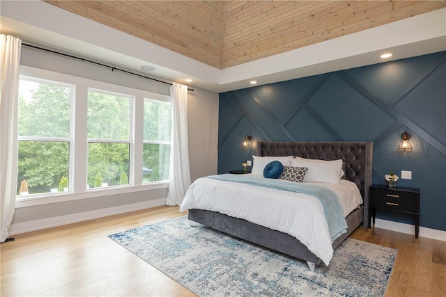 2762 Wilson Ln, Fayetteville, AR 72703 - bedroom featuring multiple windows, baseboards, wood finished floors, a decorative wall, and recessed lighting