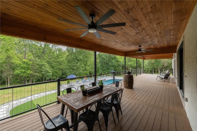 2762 Wilson Ln, Fayetteville, AR 72703 - deck featuring a ceiling fan, a lawn, a wooded view, and outdoor dining area