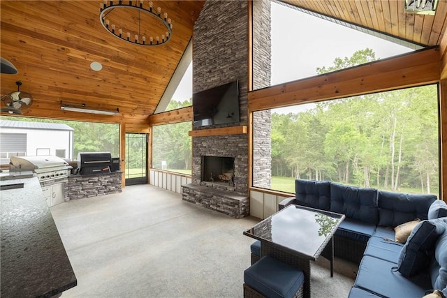 2762 Wilson Ln, Fayetteville, AR 72703 - carpeted living room with high vaulted ceiling, wood ceiling, a stone fireplace, and wooden walls