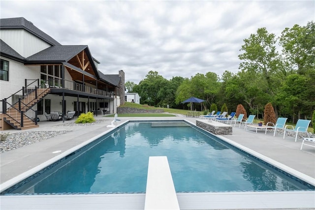 2762 Wilson Ln, Fayetteville, AR 72703 - swimming pool featuring a patio, stairway, a diving board, and a deck