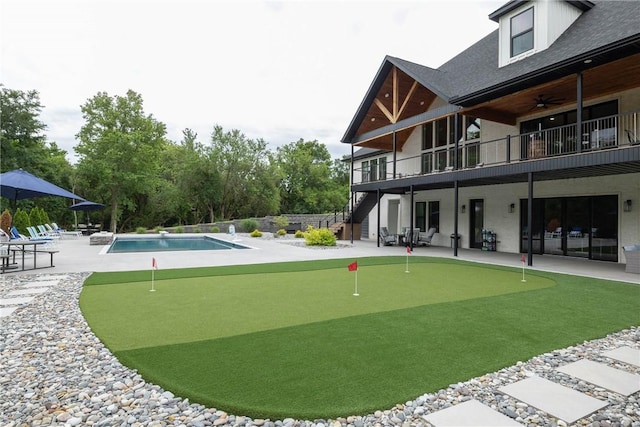 2762 Wilson Ln, Fayetteville, AR 72703 - view of yard with a putting green, a patio area, stairway, and an outdoor pool