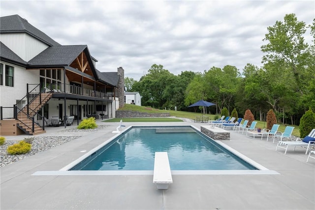 2762 Wilson Ln, Fayetteville, AR 72703 - outdoor pool with stairway, a patio, a diving board, a wooden deck, and a yard