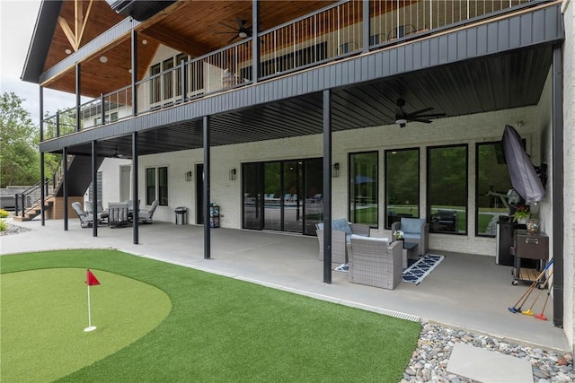 2762 Wilson Ln, Fayetteville, AR 72703 - rear view of house with ceiling fan, a putting area, a patio, and a balcony