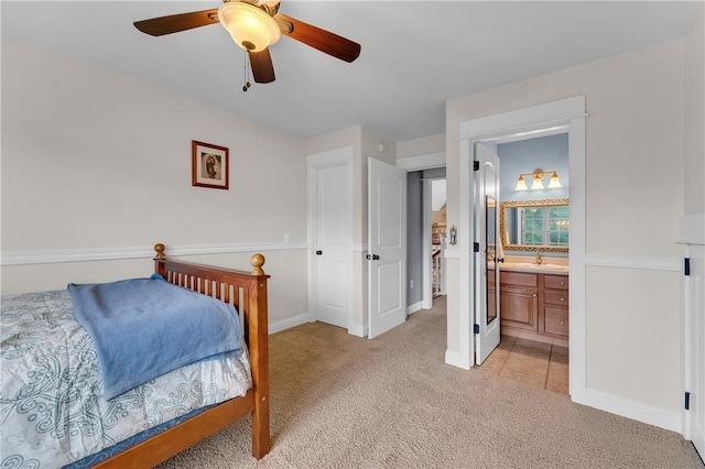 12292 Butler Rd, Prairie Grove, AR 72753 - bedroom featuring light carpet, baseboards, connected bathroom, and a ceiling fan