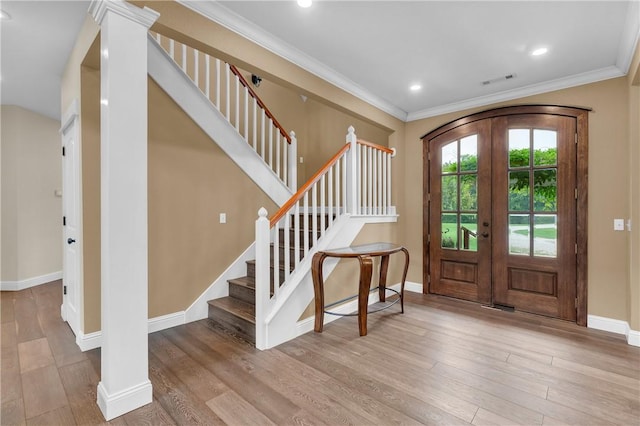 12292 Butler Rd, Prairie Grove, AR 72753 - foyer entrance with french doors, wood finished floors, stairway, baseboards, and crown molding