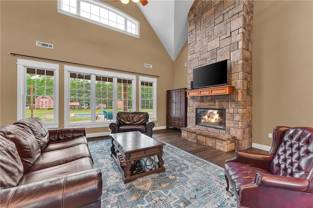 12292 Butler Rd, Prairie Grove, AR 72753 - living area with a fireplace, wood finished floors, ceiling fan, high vaulted ceiling, and baseboards