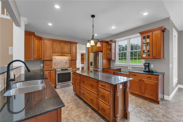 12292 Butler Rd, Prairie Grove, AR 72753 - kitchen with stainless steel appliances, a sink, brown cabinets, a kitchen island, and tasteful backsplash