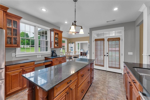 12292 Butler Rd, Prairie Grove, AR 72753 - kitchen with french doors, brown cabinets, recessed lighting, a kitchen island, and hanging light fixtures