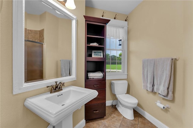 12292 Butler Rd, Prairie Grove, AR 72753 - bathroom with toilet, tile patterned flooring, baseboards, and a shower with door