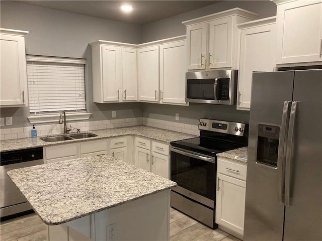 1211/1213 N Sicily Ln, Fayetteville, AR 72704 - kitchen featuring stainless steel appliances, a sink, white cabinetry, a center island, and recessed lighting