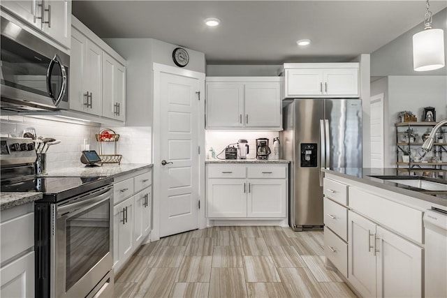 6 Briscoe Ln, Bella Vista, AR 72715 - kitchen with appliances with stainless steel finishes, a sink, decorative backsplash, light stone countertops, and white cabinets
