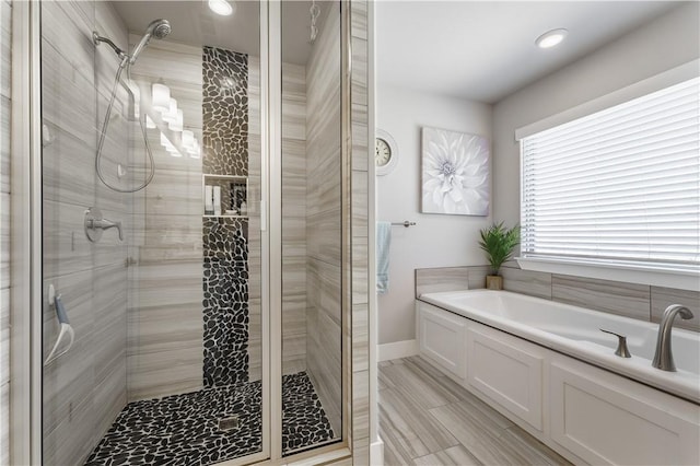 6 Briscoe Ln, Bella Vista, AR 72715 - full bathroom with a garden tub, a stall shower, recessed lighting, and baseboards