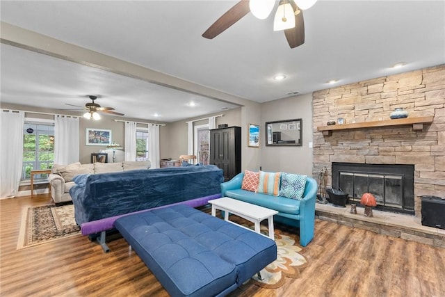 14090 Canal St, Rogers, AR 72758 - living area with a ceiling fan, wood finished floors, plenty of natural light, a stone fireplace, and recessed lighting