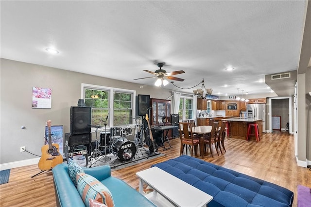 14090 Canal St, Rogers, AR 72758 - living room featuring light wood-style floors, baseboards, ceiling fan, and recessed lighting