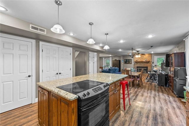 14090 Canal St, Rogers, AR 72758 - kitchen featuring range with electric cooktop, dark wood-style flooring, brown cabinetry, open floor plan, and recessed lighting
