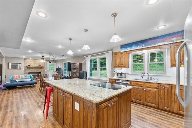14090 Canal St, Rogers, AR 72758 - kitchen featuring a sink, stainless steel appliances, light wood-type flooring, brown cabinets, and recessed lighting