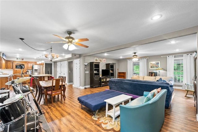 14090 Canal St, Rogers, AR 72758 - living room featuring ceiling fan, light wood-style floors, recessed lighting, and a chandelier