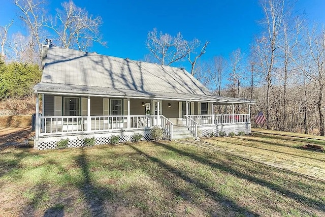 14090 Canal St, Rogers, AR 72758 - farmhouse featuring covered porch, metal roof, and a front lawn