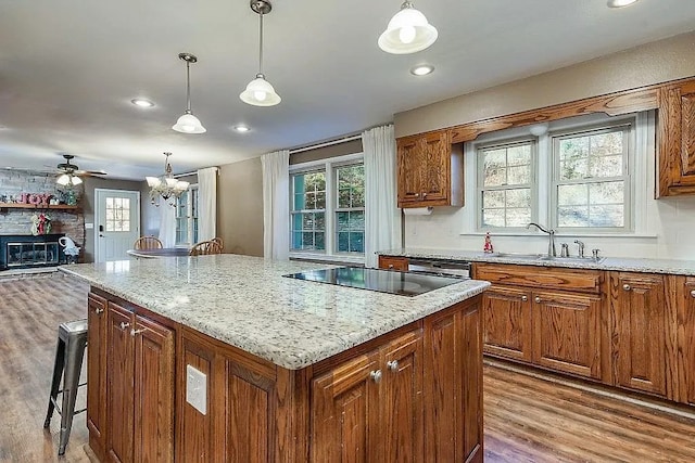 14090 Canal St, Rogers, AR 72758 - kitchen featuring black electric stovetop, wood finished floors, a kitchen island, a sink, and recessed lighting