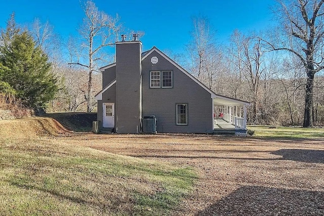 14090 Canal St, Rogers, AR 72758 - view of side of home with a porch, central air condition unit, and a chimney