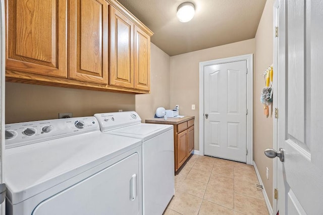 809 Irelan, Lowell, AR 72745 - laundry room with cabinet space, washer and clothes dryer, light tile patterned floors, and baseboards