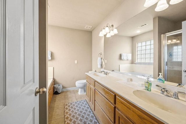 809 Irelan, Lowell, AR 72745 - bathroom with double vanity, a shower stall, a garden tub, toilet, and tile patterned floors