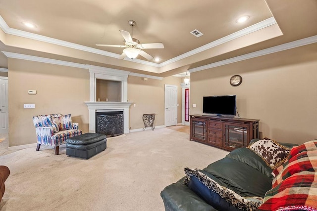 809 Irelan, Lowell, AR 72745 - carpeted living area featuring a tray ceiling, ornamental molding, ceiling fan, baseboards, and a fireplace