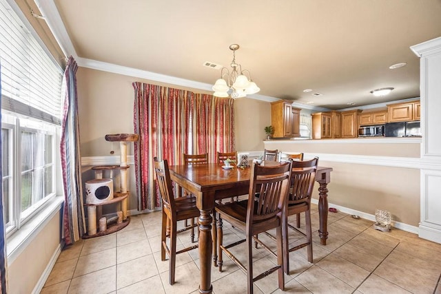 809 Irelan, Lowell, AR 72745 - dining space featuring healthy amount of natural light, ornamental molding, light tile patterned flooring, and a chandelier