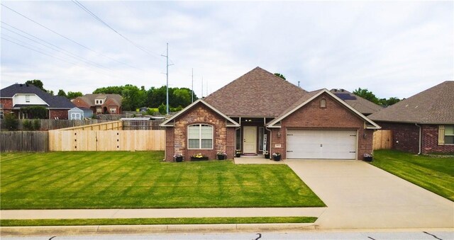 1011 Harvest St, Centerton, AR 72719 - view of front of house featuring an attached garage, driveway, brick siding, and roof with shingles