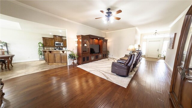 1011 Harvest St, Centerton, AR 72719 - living room featuring ceiling fan, crown molding, and light wood-style floors